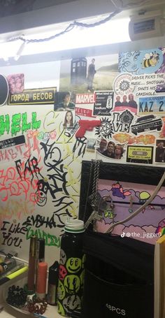 the wall is covered with graffiti and stickers