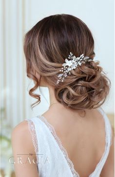 the back of a woman's head wearing a bridal hair comb