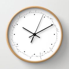 a white clock with black hands and numbers on it