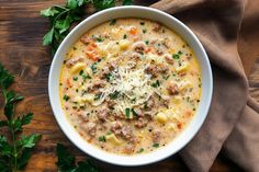 a white bowl filled with pasta and meat soup