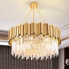 a large chandelier hanging from the ceiling in a room with curtains and windows