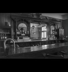 an old fashioned bar with lots of bottles on it