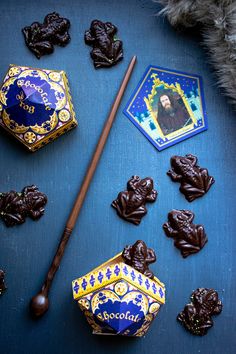 chocolate candies and an incense stick on a blue surface with other items around them