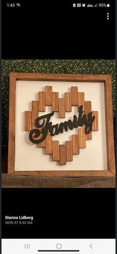 a wooden frame with the word family cut out in it's center and an image of