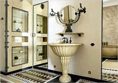 a fancy bathroom with black and white checkered flooring on the walls, an ornate pedestal sink and mirror