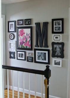 the wall is covered with many framed photos and letters that spell out mom on it