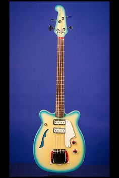 a yellow and blue guitar sitting on top of a table