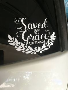 a sticker that says saved by grace on the side of a car