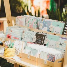 a wooden table topped with lots of greeting cards