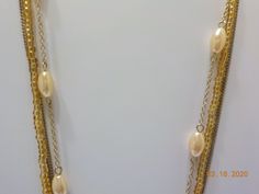 "Vintage gold tone triple strand choker necklace. One strand with pale faux pearls, two srands of gold tone chains, & the other strand is tiny gold tone plastic beads. 2\" extension chain. Lobster claw fastener. Classic!" Gold Chain Pearl Necklace In Costume Jewelry Style, Gold Pearl Necklace With Chain In Costume Style, Gold Layered Necklace With Pearl Chain For Party, Double Strand Gold Chain Necklace With Beads, Gold Double Strand Chain Necklace With Beads, Gold Layered Necklace With Beaded Chain, Gold Pearl Layered Necklace With Beaded Chain, Gold Layered Necklace With Pearl Chain, Adjustable Gold Pearl Necklace For Party