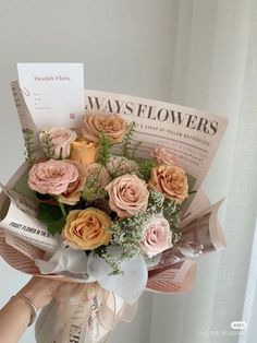 a person holding a bouquet of flowers in front of a window with an advertisement on it