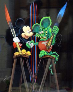 mickey mouse and goofy the frog on top of skis