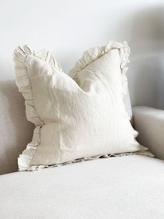 a white pillow sitting on top of a couch