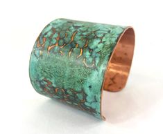 These unique, hand-formed copper and brass cuff bracelets with vibrant patinas create stunning accents to your personal style. Dress up or down- either way you'll be wearing an adornment that will turn heads, start conversations, and delight the eye of the beholder. This is a copper cuff with a beautiful blue-green marbled patina that has been lifted away in spots to reveal the hammer marks in the metal. Please note that patina colors will look different depending on the screen/device you view t Unique Hammered Copper Bracelets, Unique Handmade Copper Bangle, Handmade Unique Copper Bangle, Electroformed Copper Cuff Bracelet Gift, Unique Hammered Copper Cuff Bracelet, Artisan Bronze Copper Cuff Bracelet, Artisan Electroformed Cuff Bangle Bracelet, Hand Forged Bronze Copper Cuff Bracelet, Artistic Patina Cuff Bracelet As Gift