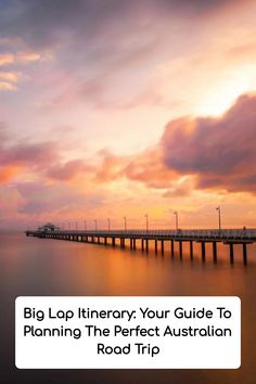 a long pier sitting on top of a body of water under a cloudy blue sky