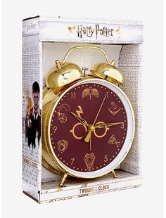 the harry potter alarm clock is in its box with it's gold bell and hands