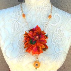 "This stunning Sari Ribbon Flower Statement Necklace is made from recycled Orange Sari Ribbon and the Pendant is a beautiful Solar Quartz Slice.  Sari Ribbon Flower with Solar Quartz Pendant   18\"s, 20\"s or 22\"s in length -        plus Gold Plated 3\" extender chain  Free US Shipping and Dangle Earrings  Ships in 1 Day  Gift Wrapping Available This is a must have very Unique Statement piece. Enjoy this labor of love.  Oh! This would make an amazing Gift for that Special Someone! Free US Shipp Unique Orange Flower Shaped Jewelry, Unique Orange Flower-shaped Jewelry, Bohemian Orange Flower Necklace, Orange Bohemian Flower Necklace, Bohemian Orange Flower Jewelry, Bohemian Orange Flower-shaped Jewelry, Orange Bohemian Flower-shaped Jewelry, Fabric Flower Necklace, Sari Ribbon