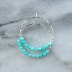 Think of these semi precious beaded hoop earrings as Libby & Smee Deluxe! Quite simply, these'll be the hoops that you'll want to wear every single day. 45mm (about 1.75") gold-filled or sterling silver hoops with faceted Amazonite gemstone beads packaged on a kraft earring card in a clear resealing bag gold-filled hoops are lead-free gold over brass. Gold-filled has much more gold than gold-plated and will last longer without tarnishing. Not sure which gemstone to choose? This blog post mig Earring Card, Gold Filled Hoops, Earring Cards, Beaded Hoop Earrings, Beaded Hoops, Brass Gold, Every Single Day, Sterling Silver Hoops, Silver Hoops