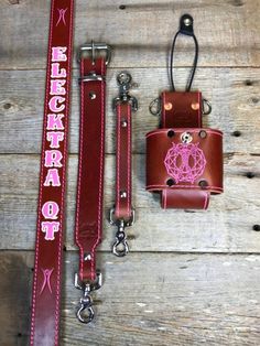 a pink and brown belt with a matching lanyard, keychain and wallet