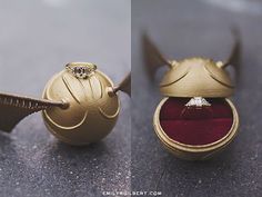 an open ring box sitting on top of a table next to a small gold object