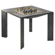 a table with chess pieces on it and a board in the middle, sitting next to each other