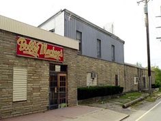 a brick building with a red sign on it