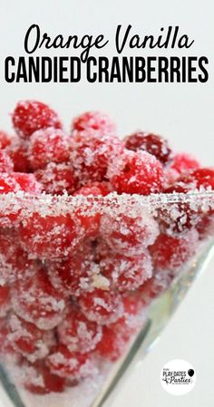 orange vanilla candied cranberries in a glass bowl with powdered sugar on top