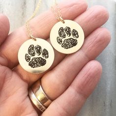 Shipping today: Actual paw prints engraved on our 7/8” gold filled discs. I love how different and unique each of these turns out! Gold Sterling Silver Jewelry With Paw Print, Paw Print Round Pendant Jewelry For Gift, Silver Paw Print Jewelry For Personalized Gift, Paw Print Pendant Necklace Gift, Paw Print Pendant Necklace For Gifts, Personalized Engraved Jewelry, Paw Print Pendant, Cat Paw Print, Paw Print Necklace