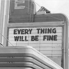 a sign that says every thing will be fine on the side of a building in black and white