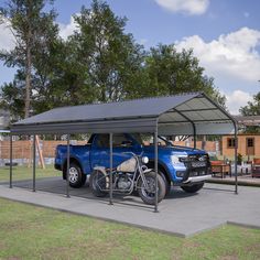 two motorcycles are parked in front of a blue pickup truck with a canopy over it