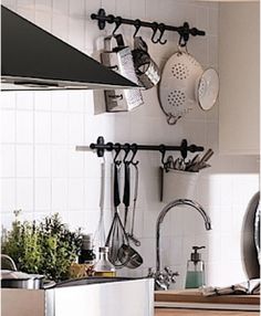 a kitchen with pots and pans hanging on the wall above the stove top oven