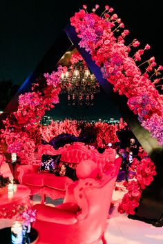 a room filled with lots of pink flowers and furniture