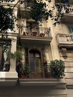 an apartment building with balconies and plants on the balcony