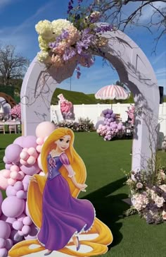 a princess balloon arch in the middle of a lawn with flowers and balloons on it