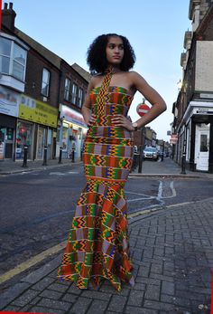 CUSTOM MADE: Our prom dresses are to be custom made in any fabric seen - tell us your size and fabric, and we will get it to you for your special day! This beautiful elegant Kente dress with fish tale front and back bottom is fully lined with back zip, which will make a statement for any special event   Body-Corn fit with flare bottom Halter neck line Back zip Sleeveless 100% Cotton Delivery will be between 2 to 3 weeks for tailor-made products! African Print Prom Dress, Prom Dress High Neck, Prom Dress African, African Clothing Stores, Ankara Long Gown, Ghana Fashion, High Neck Prom Dress, Kente Print, Ankara Long Gown Styles