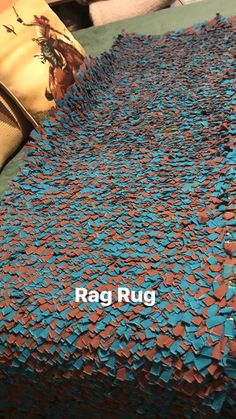 a bed covered in lots of blue and red confetti pieces with the words rag rug on it