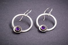 Amethyst drop earrings ideal for every occasion. Inspired from ancient Greek jewelry with a sparkle of purple Amethyst on the bottom you can wear it everyday, or on a special evening. These beautiful earrings are handmade on Sterling Silver 925. The Amethyst is 4mm diameter round Cabochon cut and set safe in a bezel. For any question, you may have, feel free to send me a message. Material: Sterling Silver 925 Gemstone: Precious Amethyst cabochon cut 4 mm diameter Finish: Shiny Width: 2,1 cm Leng Everyday Silver Amethyst Jewelry, Modern Silver Earrings With Birthstone, Modern Silver Birthstone Earrings, Nickel Free Amethyst Earrings For Anniversary, Modern Amethyst Earrings As Gift, Silver Amethyst Crystal Earrings As Gift, Minimalist Nickel-free Purple Jewelry, Purple Gemstone Earrings For Everyday Wear, Modern Purple Dangle Jewelry