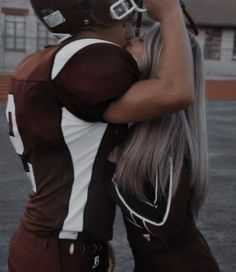 a female football player in uniform is taking a selfie