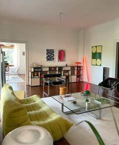 a living room filled with furniture and a fire extinguisher on top of a hard wood floor