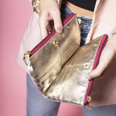 Add some color to your wallet game with this metallic leather wallet! With its multi-colored design, it's sure to make a statement. But it's not just for show - it also has plenty of room for all your cards and cash. So brighten up your daily routine with this fun and functional wallet. 7.5" L X 4.75" W X 1.25" W Trendy Gold Rectangular Wallet, Gold Leather Wallet With Zipper Closure, Gold Bifold Wallet With Zipper Closure, Gold Bifold Coin Purse For Everyday Use, Gold Clutch With Card Slots, Modern Gold Rectangular Wallets, Modern Gold Rectangular Wallet, Gold Leather Coin Purse With Interior Card Slots, Gold Leather Wallet With Card Slots