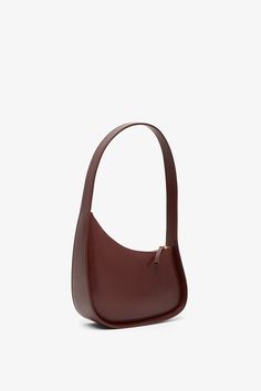 Burgundy smooth calfskin leather shoulder bag from The Row. The Half Moon bag has a beautiful silhouette, a flat shoulder strap that is perfectly curved and a zipped top. Suede lining inside.Measurements: L30 x H13 x W9 cmMade in Italy Versatile Burgundy Leather Shoulder Bag, Burgundy Leather Shoulder Bag With Smooth Grain, Burgundy Soft Leather Bag With Double Handle, The Row Half Moon Bag, On-the-go Burgundy Top Handle Shoulder Bag, Half Moon, Calf Skin, Leather Shoulder Bag, Leather Bag