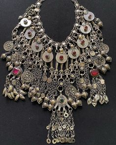 * This traditional oversized, Afghani necklace is heavily embellished with elements and material, including, stones, coins, and tassels. The long layers falling on the neck are flaunting all the traditional Afghani vibes. This craft is a staple of Afghani Kuchi Tribe, which has hundreds of years of history. You can pick it for any traditional attire or trendy outfit, as it would add the perfect amount of ethnic touch to the look. Note: The product is handmade, so slight change might occur in the Ceremonial Festival Jewelry With Coin Pendant, Traditional Handmade Pendant Coin Necklace, Traditional Handmade Coin Pendant Necklace, Handmade Traditional Coin Necklace, Bohemian Long Necklace For Ceremonial Occasions, Bohemian Long Necklace For Ceremonies, Ceremonial Medallion Necklace For Festivals, Bohemian Jewelry For Ceremonial Festival, Antique Handmade Coin Necklace For Festival