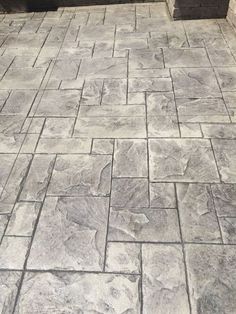 an outdoor patio with stone pavers and potted plants