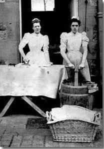 two men standing next to each other in front of a table