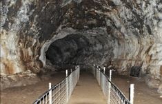 the entrance to an underground tunnel with metal railings