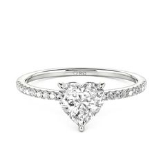 a pear shaped diamond engagement ring on a white background