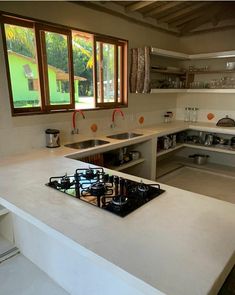 a kitchen with a stove top oven sitting next to a window