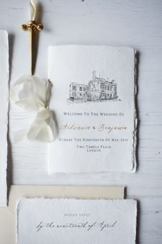 the wedding stationery is laid out on top of each other