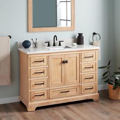 a bathroom vanity with two sinks and a mirror