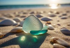 sea glass sitting on the sand at the beach